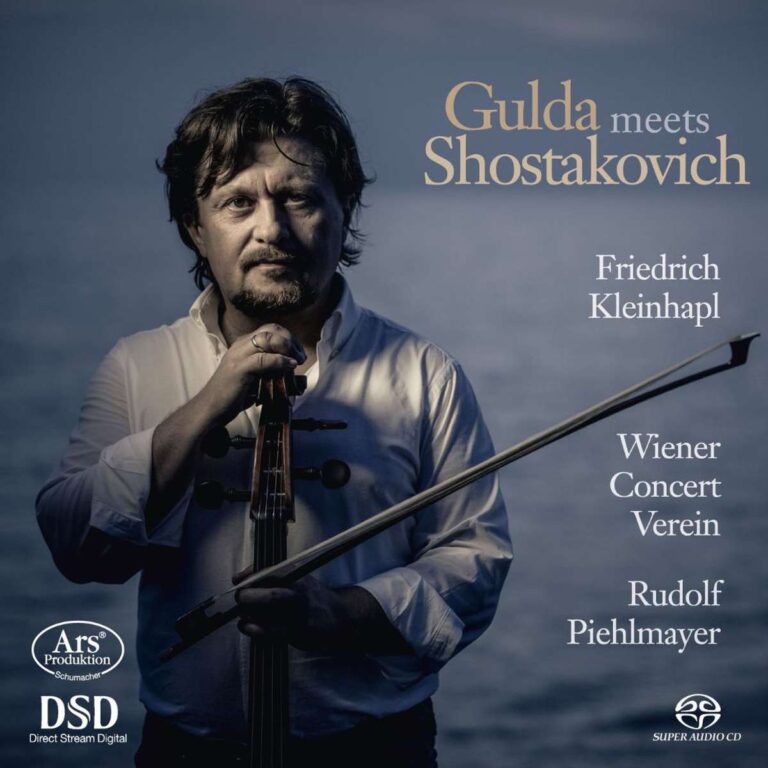 Cover des Albums 'Gulda meets Shostakovich' von Friedrich Kleinhapl, Wiener Concert Verein, und Rudolf Piehlmayer. Das Bild zeigt einen Mann mit dunklen Haaren und Bart, der ein Cello in der Hand hält. Der Hintergrund ist blau, und der Albumtitel sowie die Namen der Künstler sind in beiger Schrift auf dem Bild zu sehen. Unten links befinden sich die Logos von 'Ars Produktion' und 'DSD Direct Stream Digital